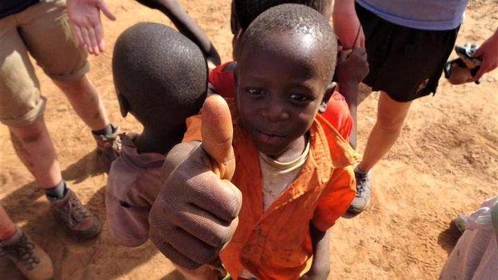 A young boy with his thumb up