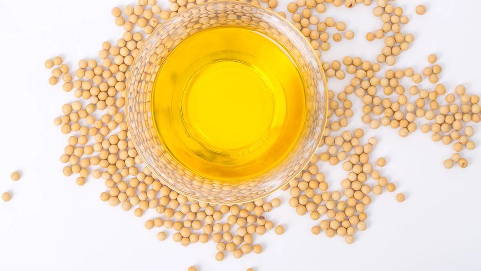 Top view of soybeans and a bowl of soybean oil