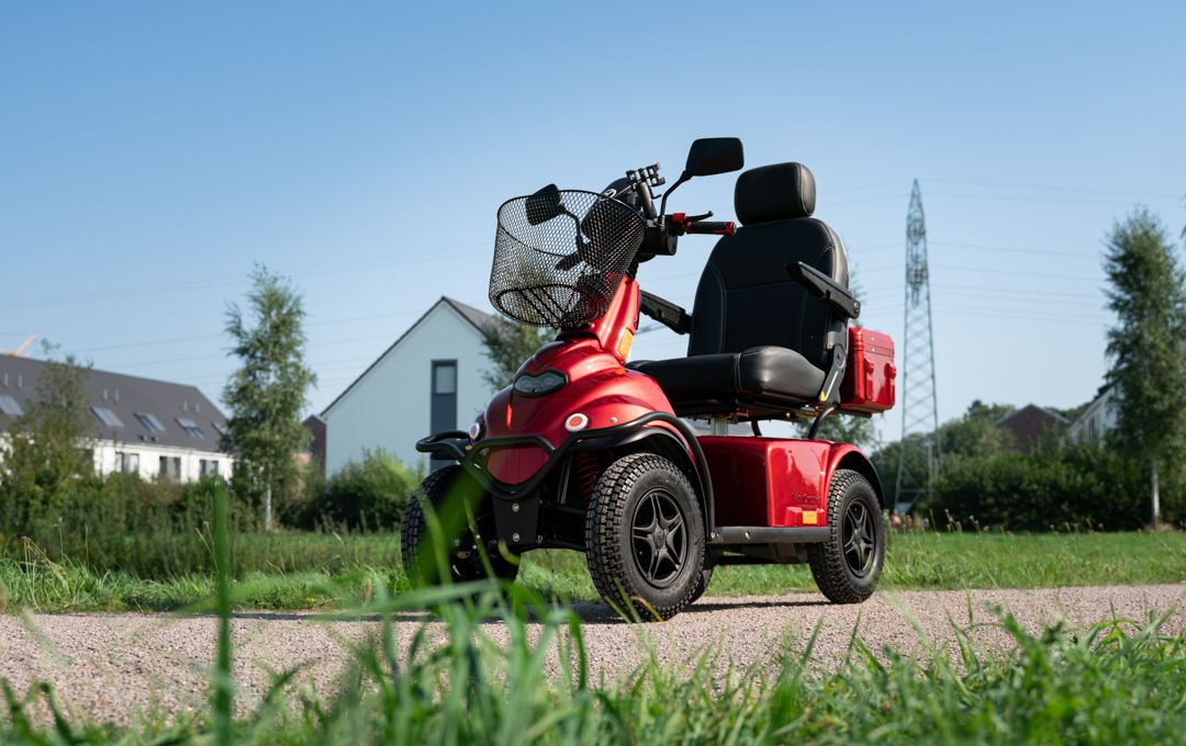Senior fährt Elektromobil über einen Landweg