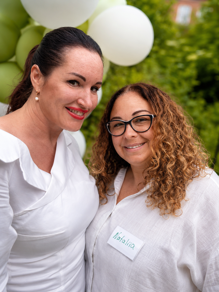 Two WECODA members smiling at the gathering