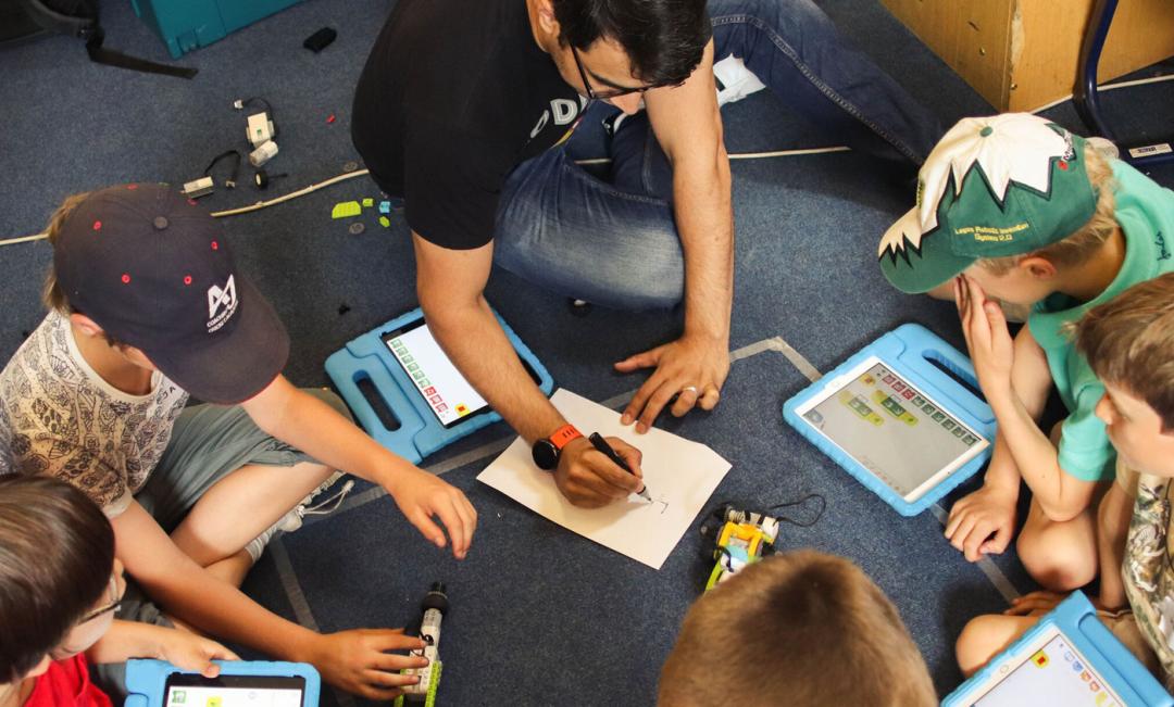 Kids learning to code in an office
