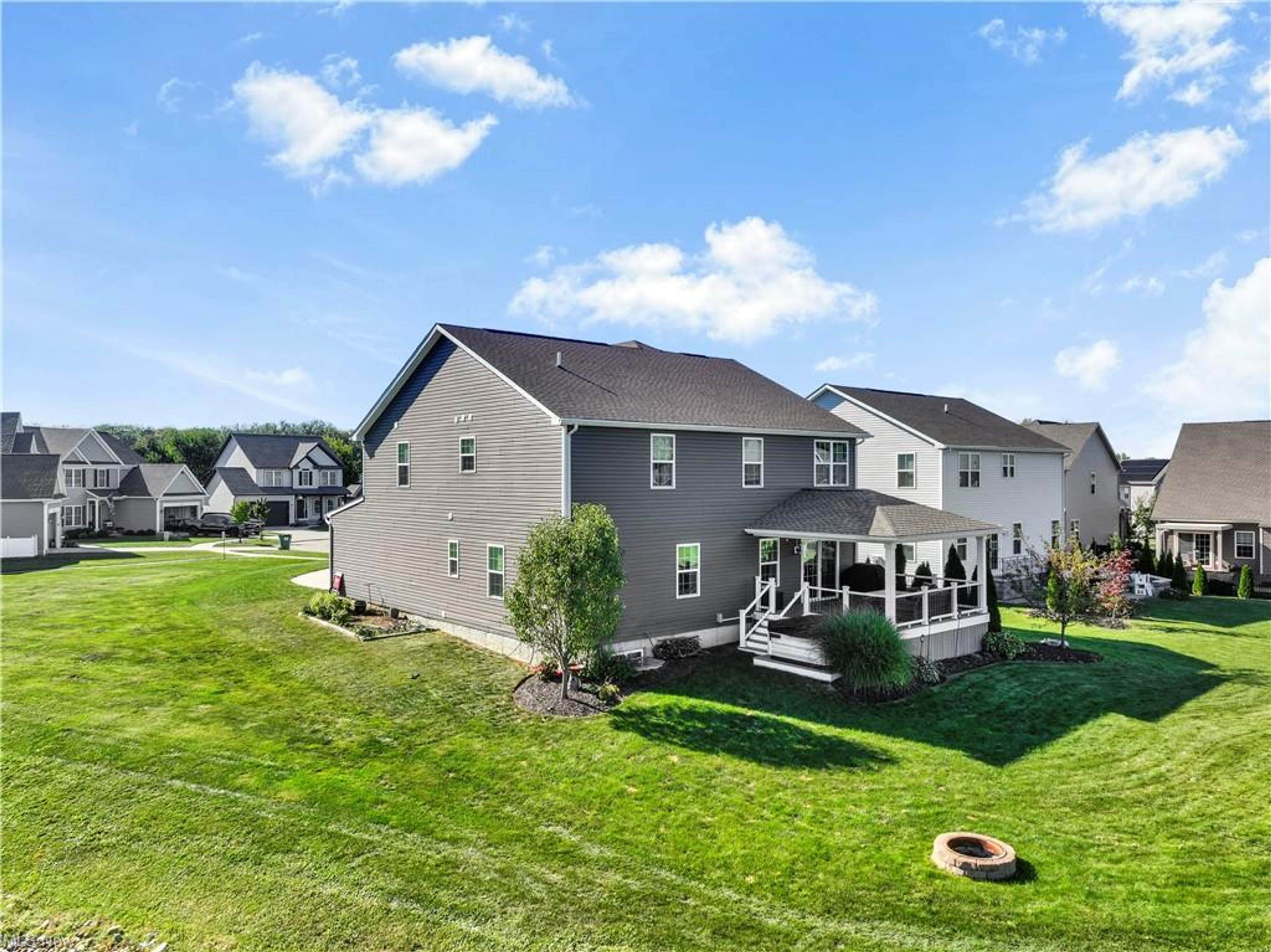Rear exterior with covered porch and open green space