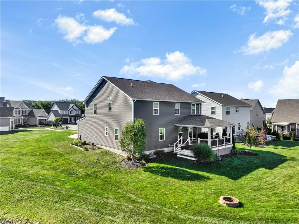 Rear exterior of 8331 Brodie Blvd with covered porch and open green space