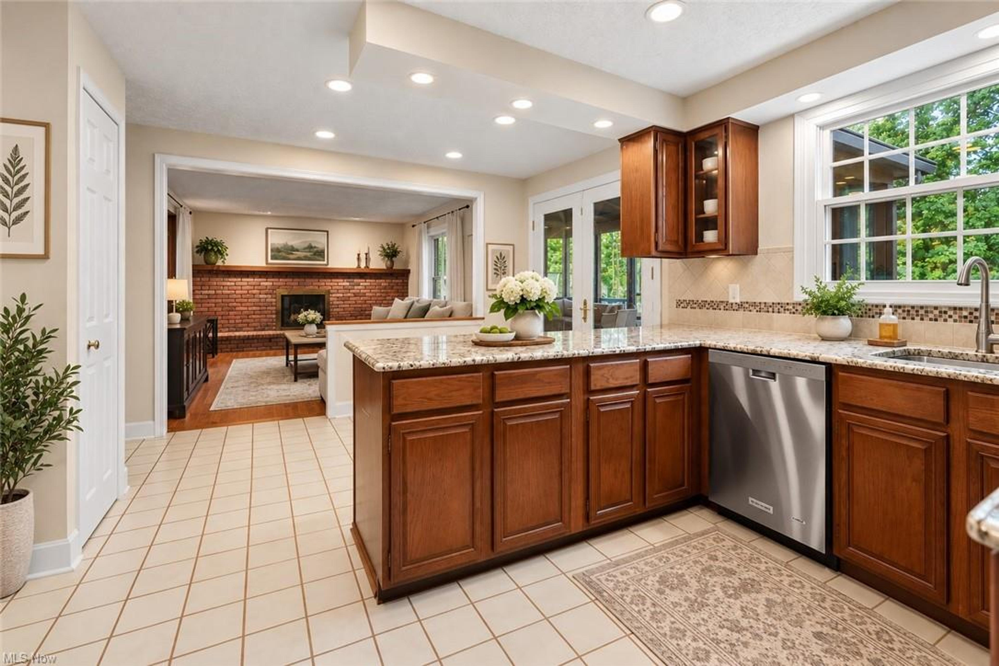 Kitchen with granite countertops and view to family room fireplace