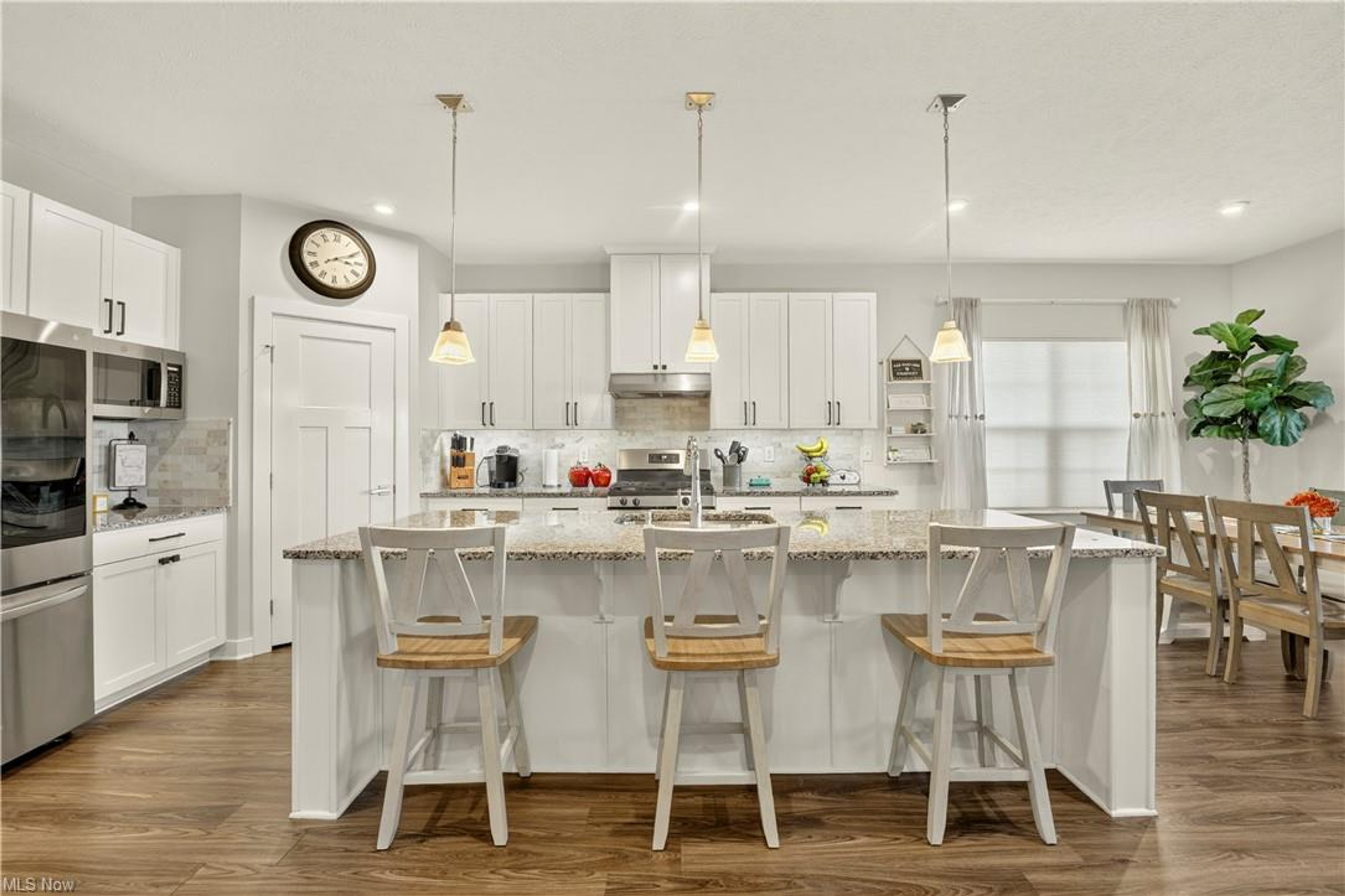Kitchen island with granite countertops and pendant lighting