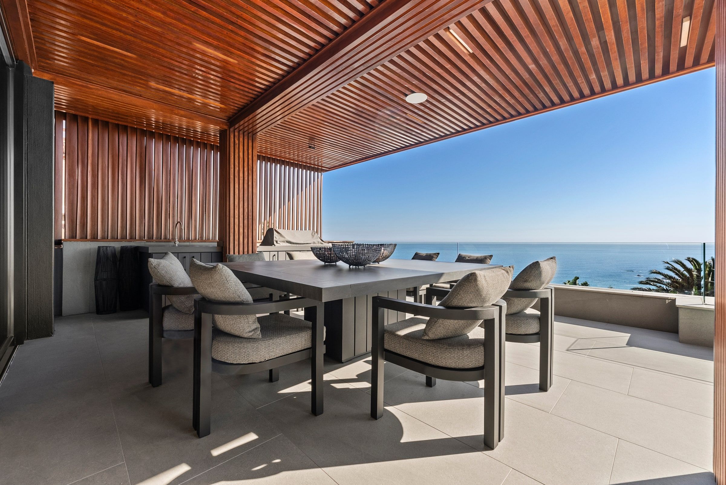 Covered outdoor dining terrace overlooking the Atlantic at Lijaro