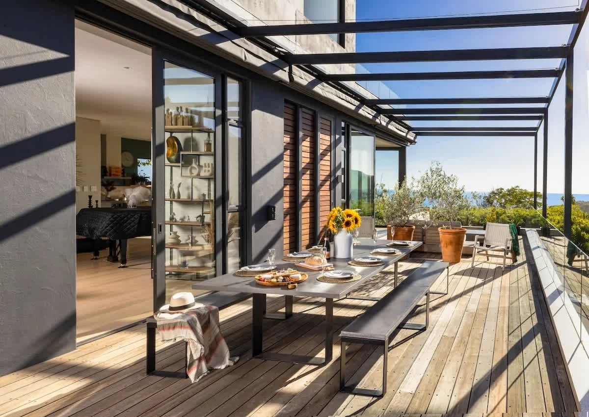 Outdoor dining area overlooking Camps Bay at Villa Lushara