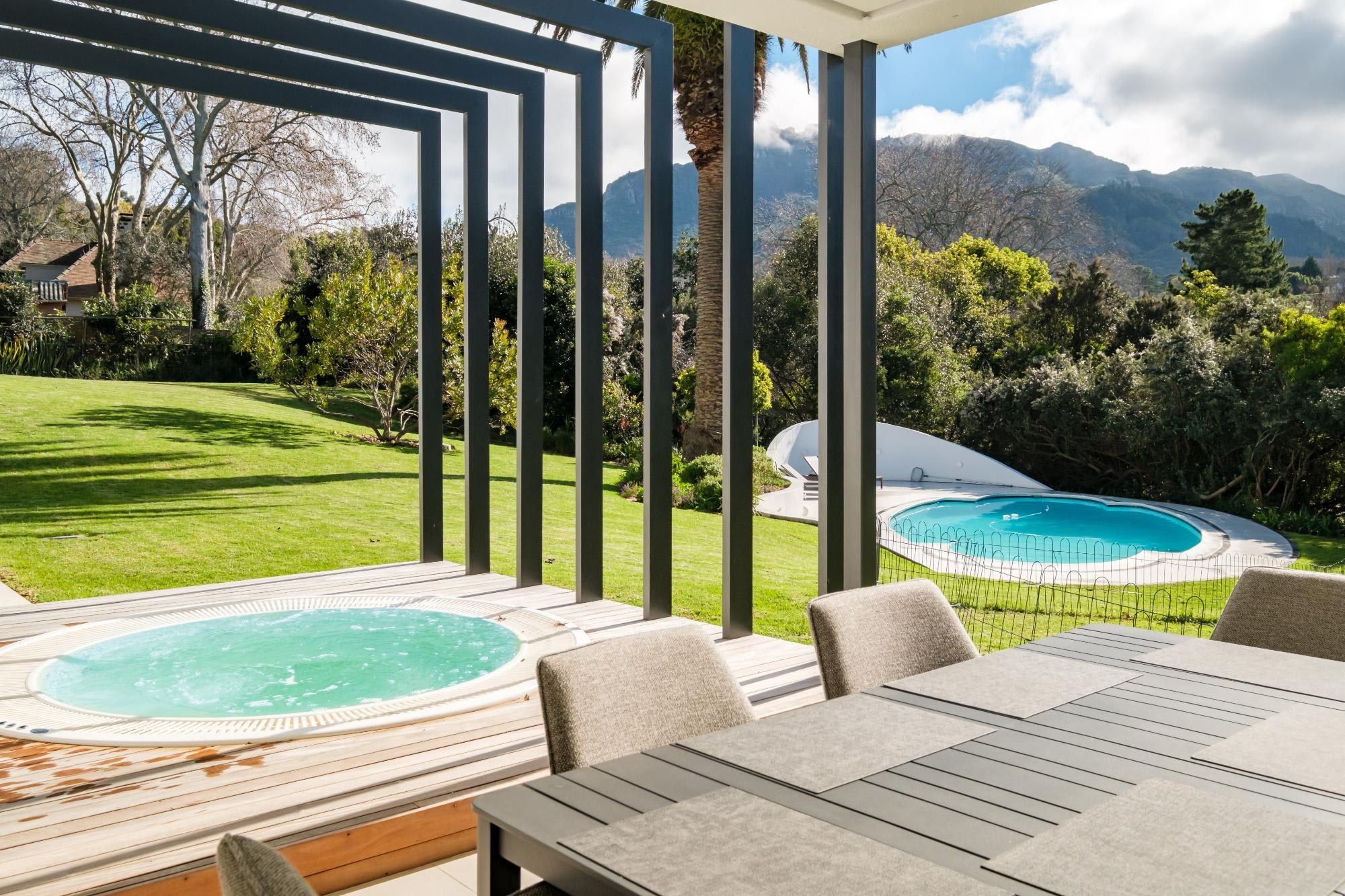 Covered patio, hot tub and garden at Solomora