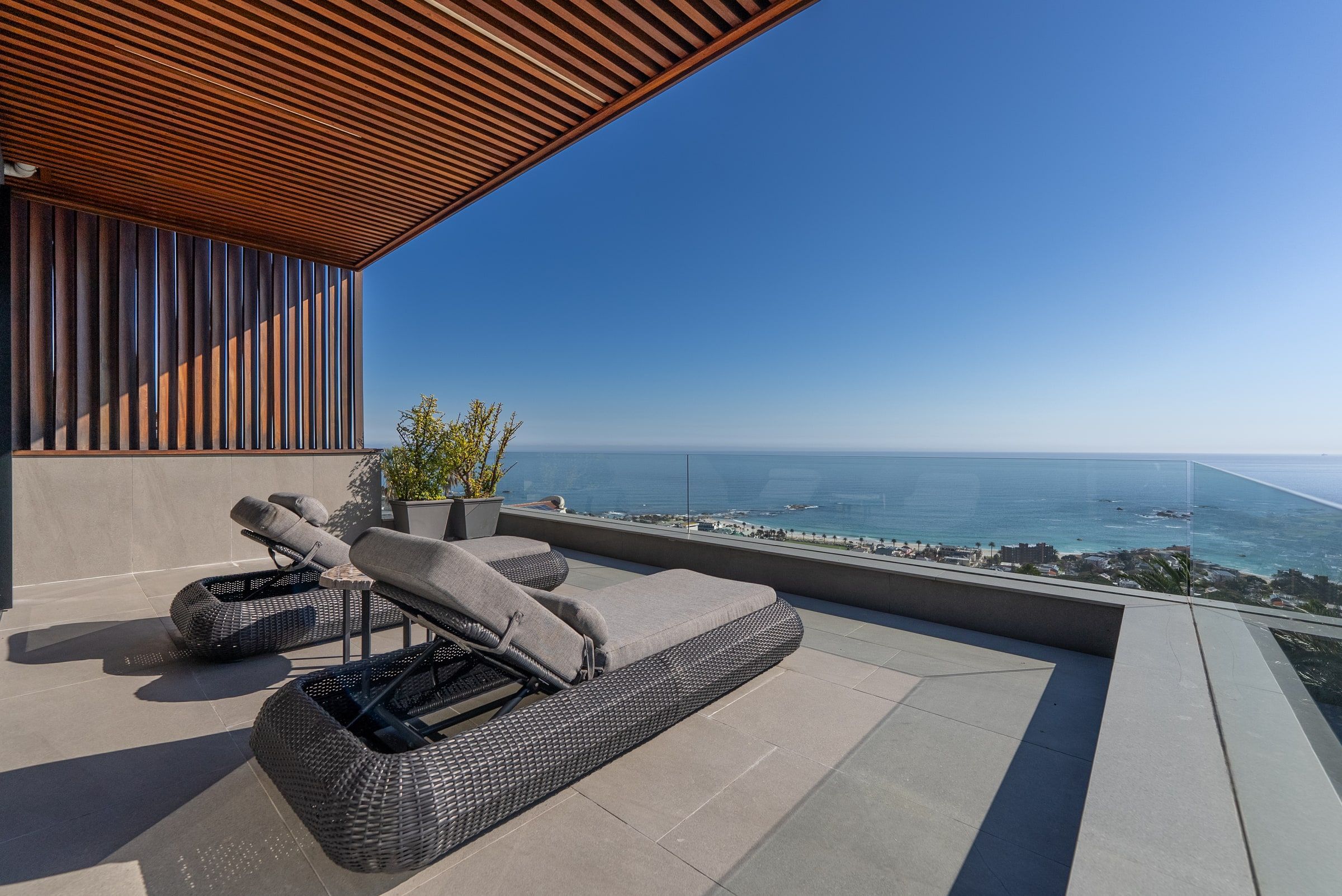 Ocean-facing sun terrace with loungers at Lijaro
