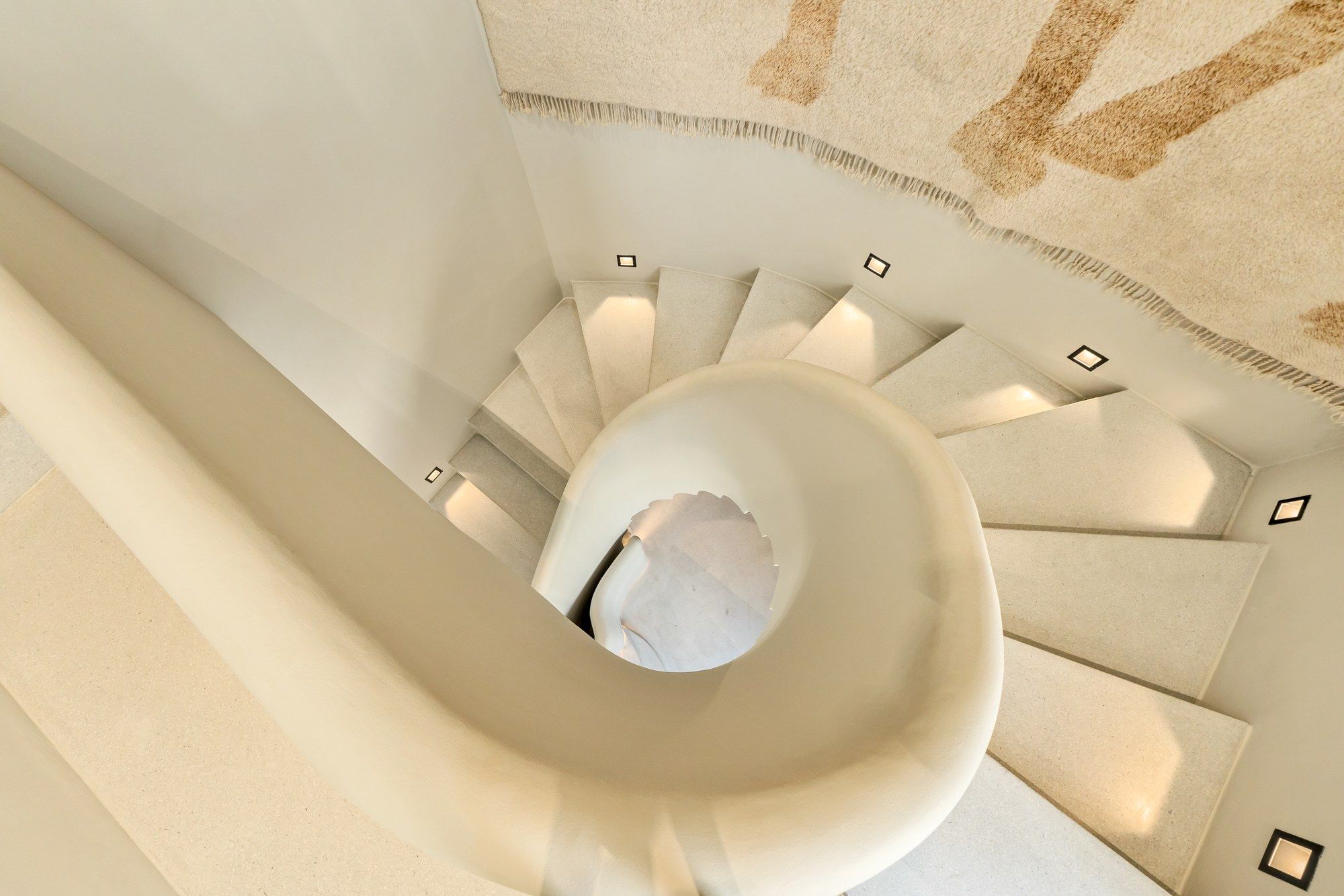 Sculptural spiral staircase at The White Camel