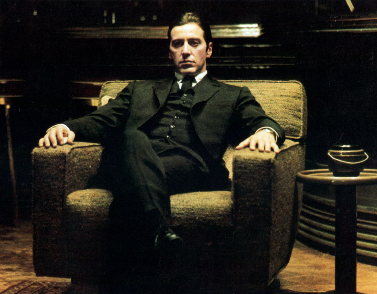 Michael Corleone in The Godfather sitting in his chair at the end of the film as the head of the crime family