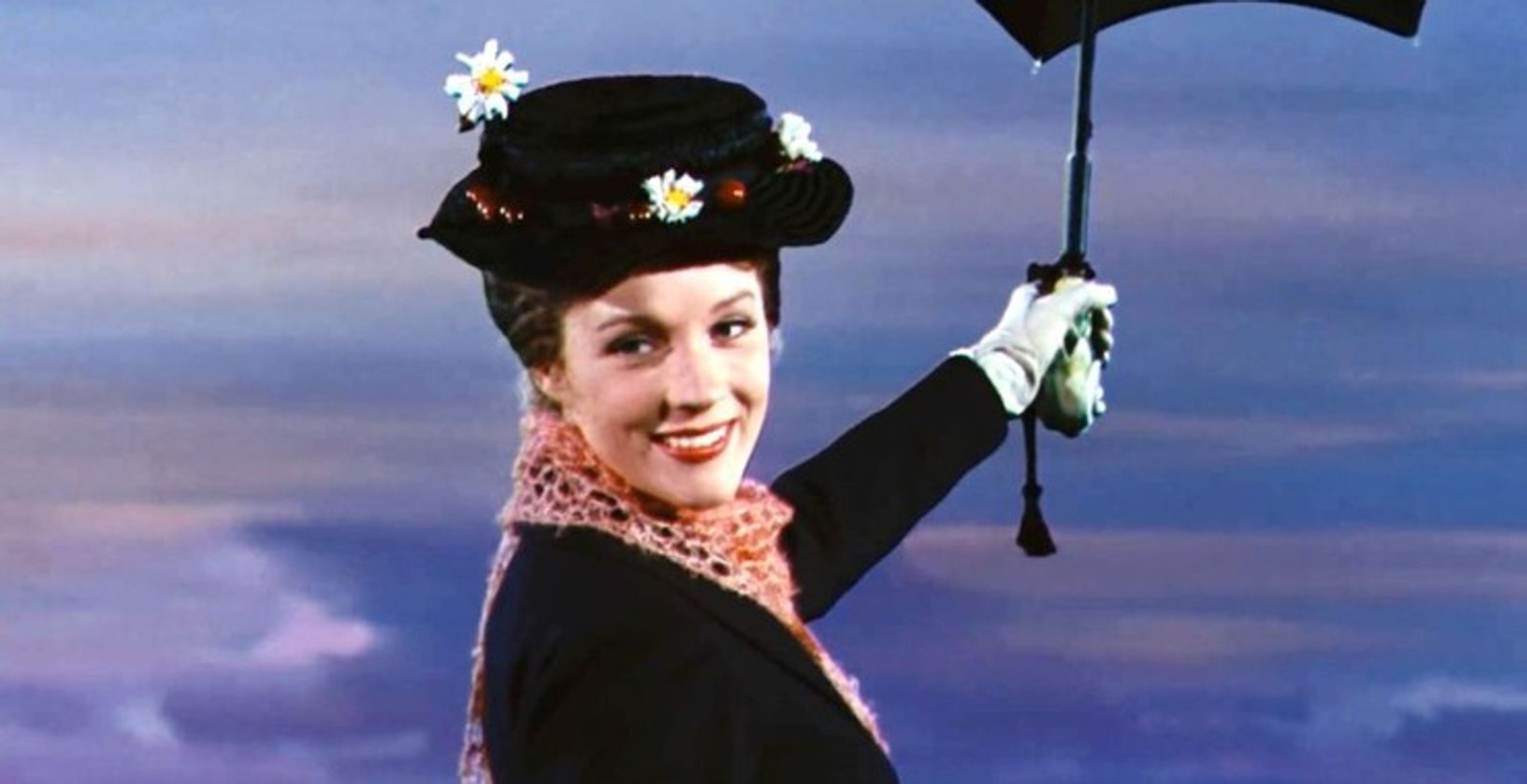 Mary Poppins pictured flying in the sky with her magical umbrella.