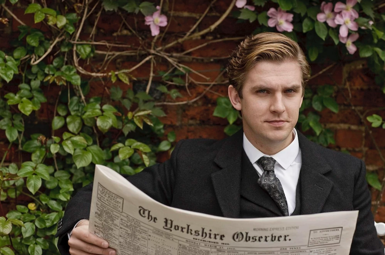 Dan Stevens, in character as Matthew Crawley reads a prop newspaper (The Yorkshire Observer)
