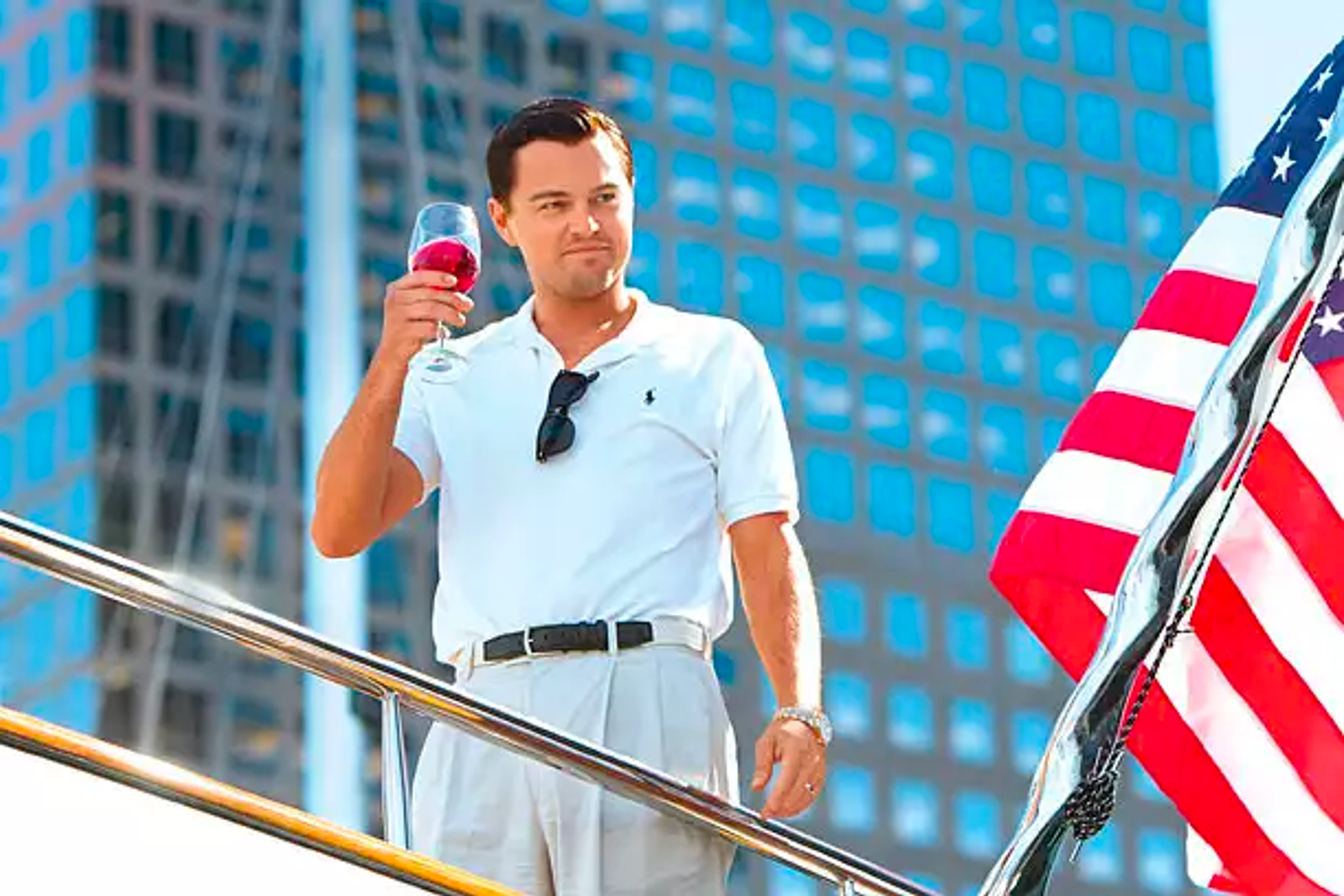 Jordan Belfort raising a glass aboard his luxury boat which he bought with the proceeds of his financial crime.  