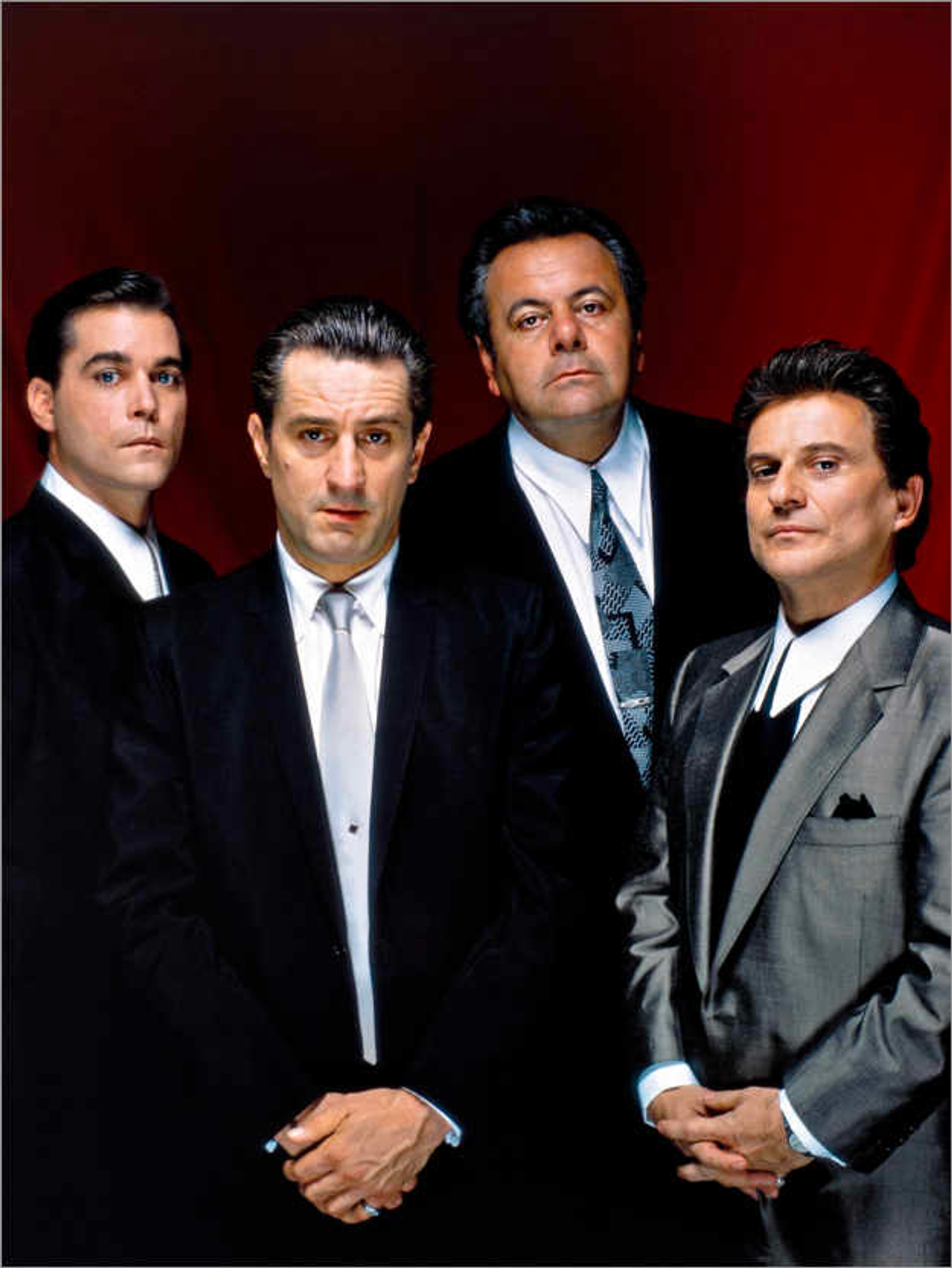 The all star cast of Goodfellas, dressed up in sharp looking suits set against a red background. 