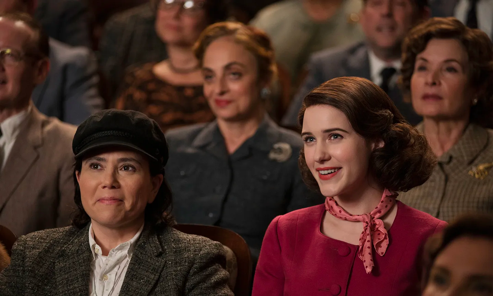 Mrs Maisel and Susie in the audience of a comedy event.
