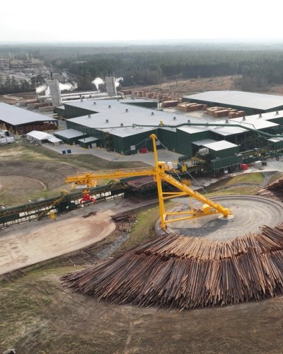 an aerial view of a large pile of logs sitting on top of a hill .