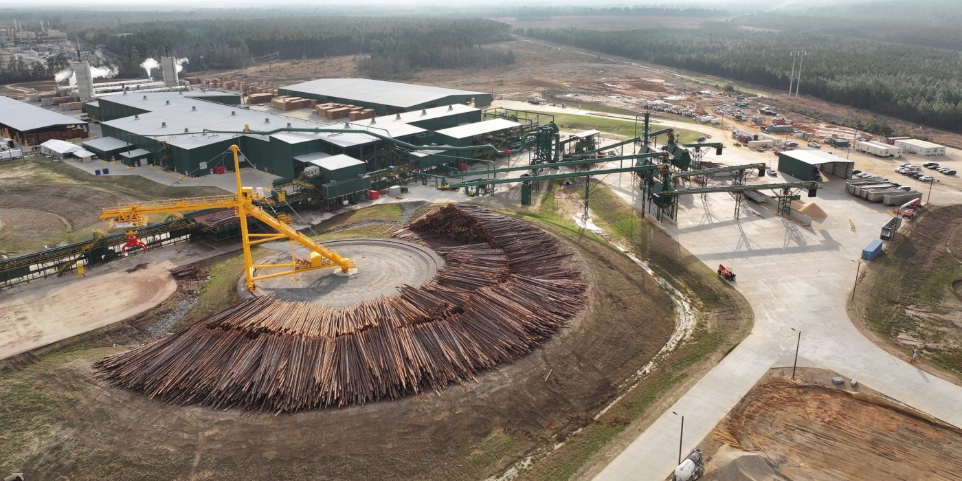 an aerial view of a large pile of logs sitting on top of a hill .
