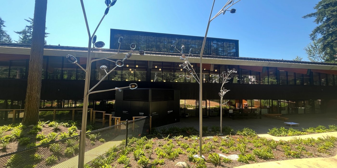 a large building with a lot of windows and trees in front of it .