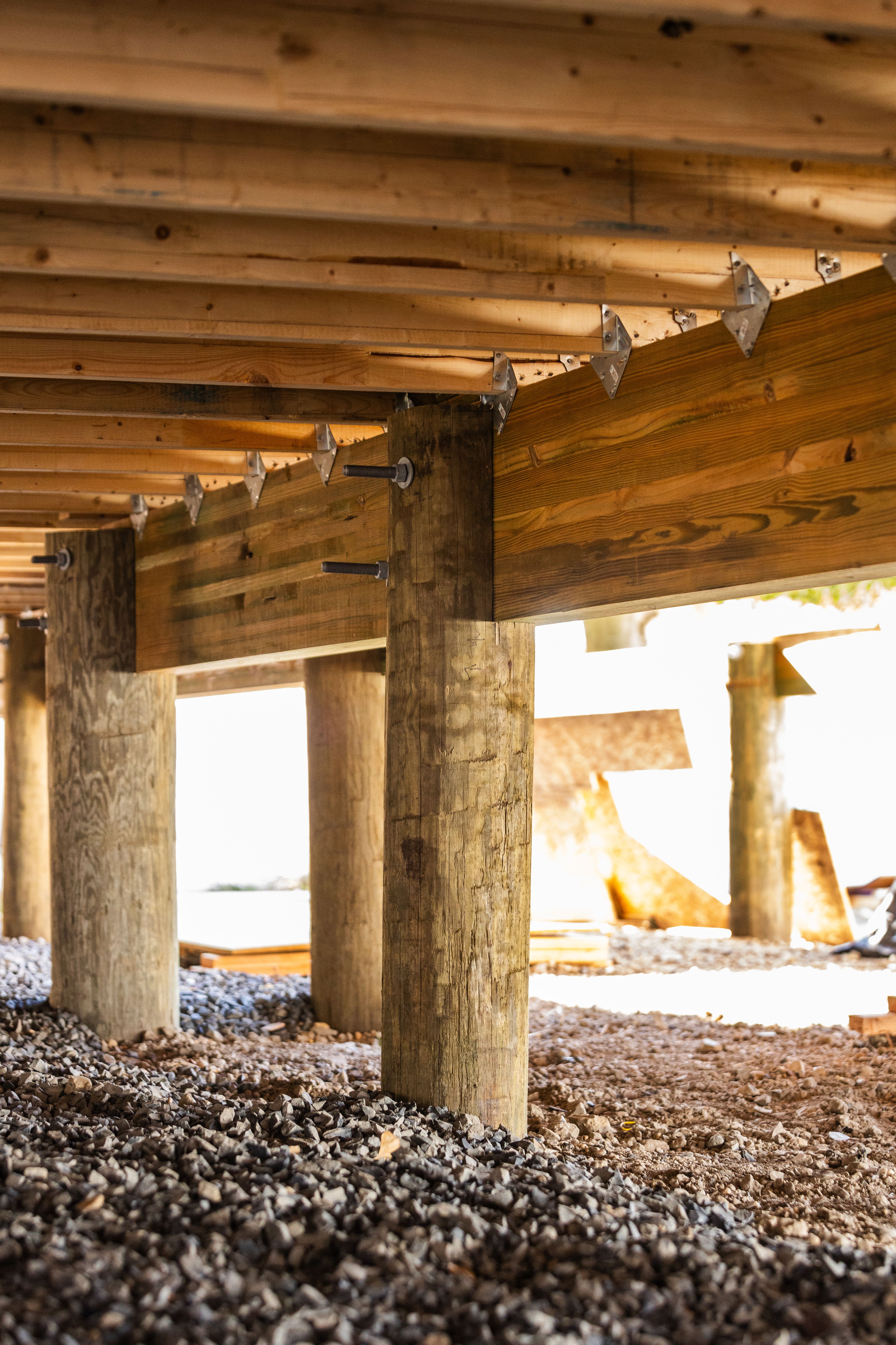 the underside of a wooden deck under construction.