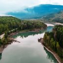 An aerial view of the Skeena River in British Columbia, surrounded by mountains and trees.
