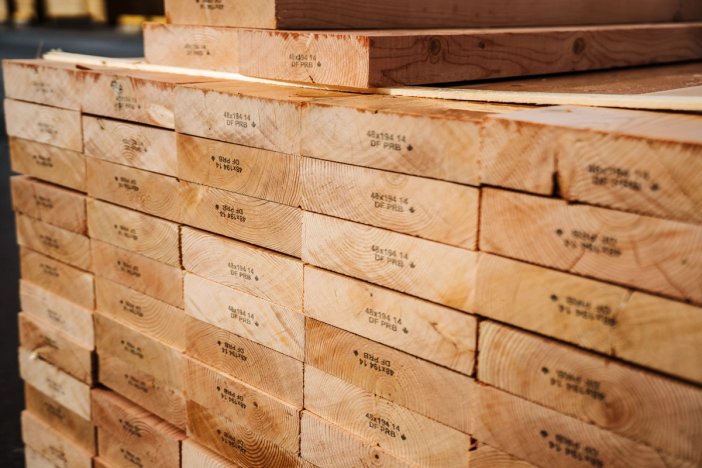 pieces of lumber are stacked on top of each other .