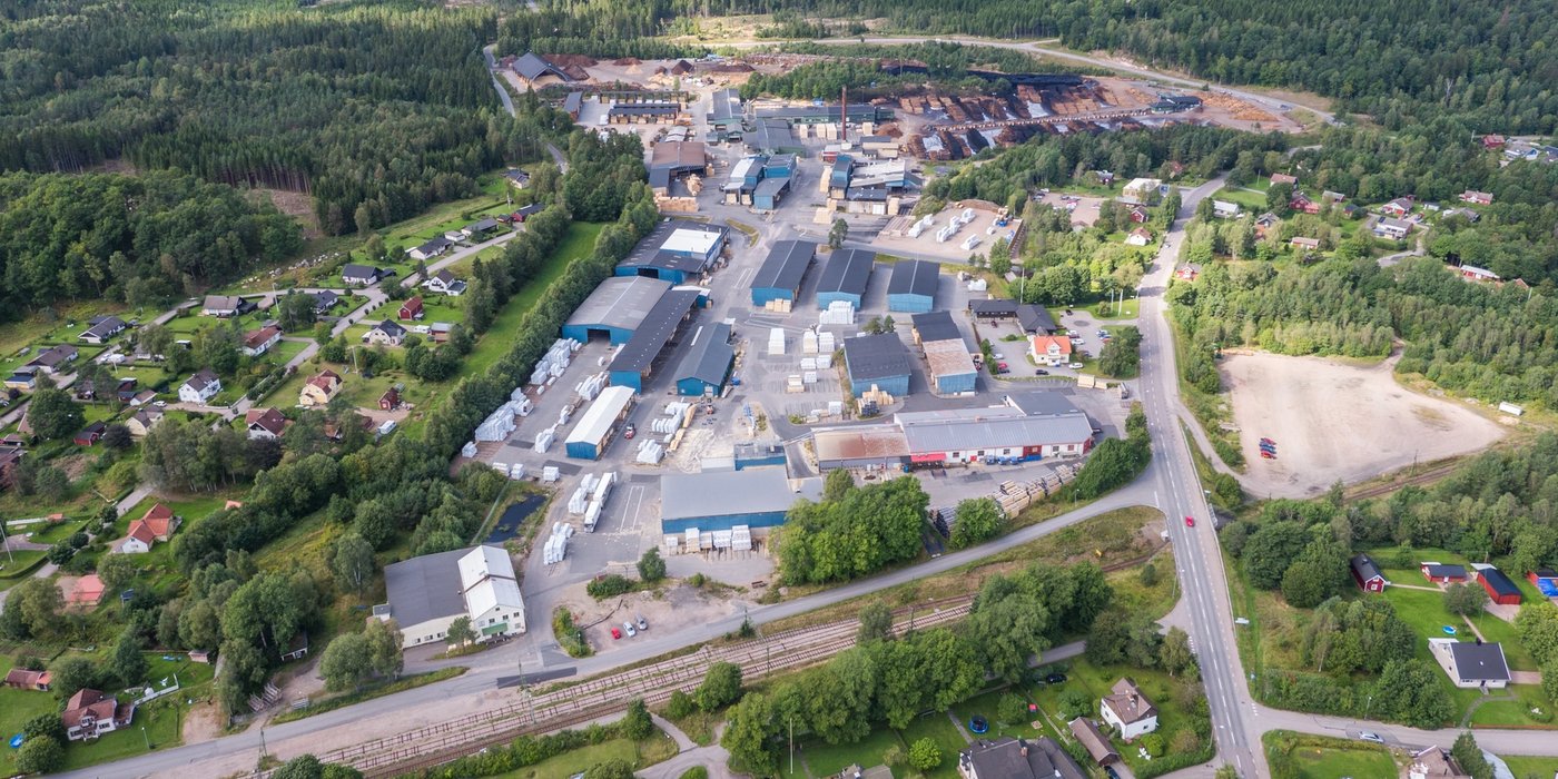 an aerial view of a small town surrounded by trees and buildings .