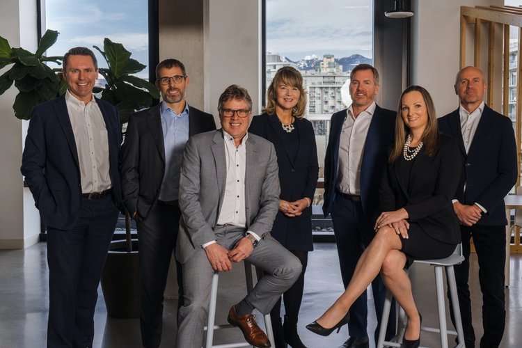 a group of business people are posing for a picture together .