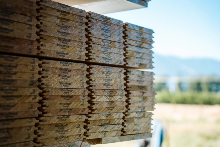 a stack of wooden boards sitting on top of each other on a shelf.