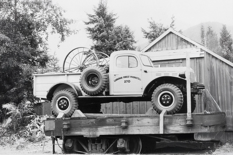 a black and white photo of a canadian forest products truck