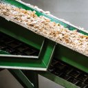 a conveyor belt transporting wood chips.