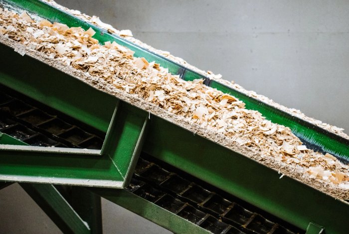 a conveyor belt transporting wood chips.