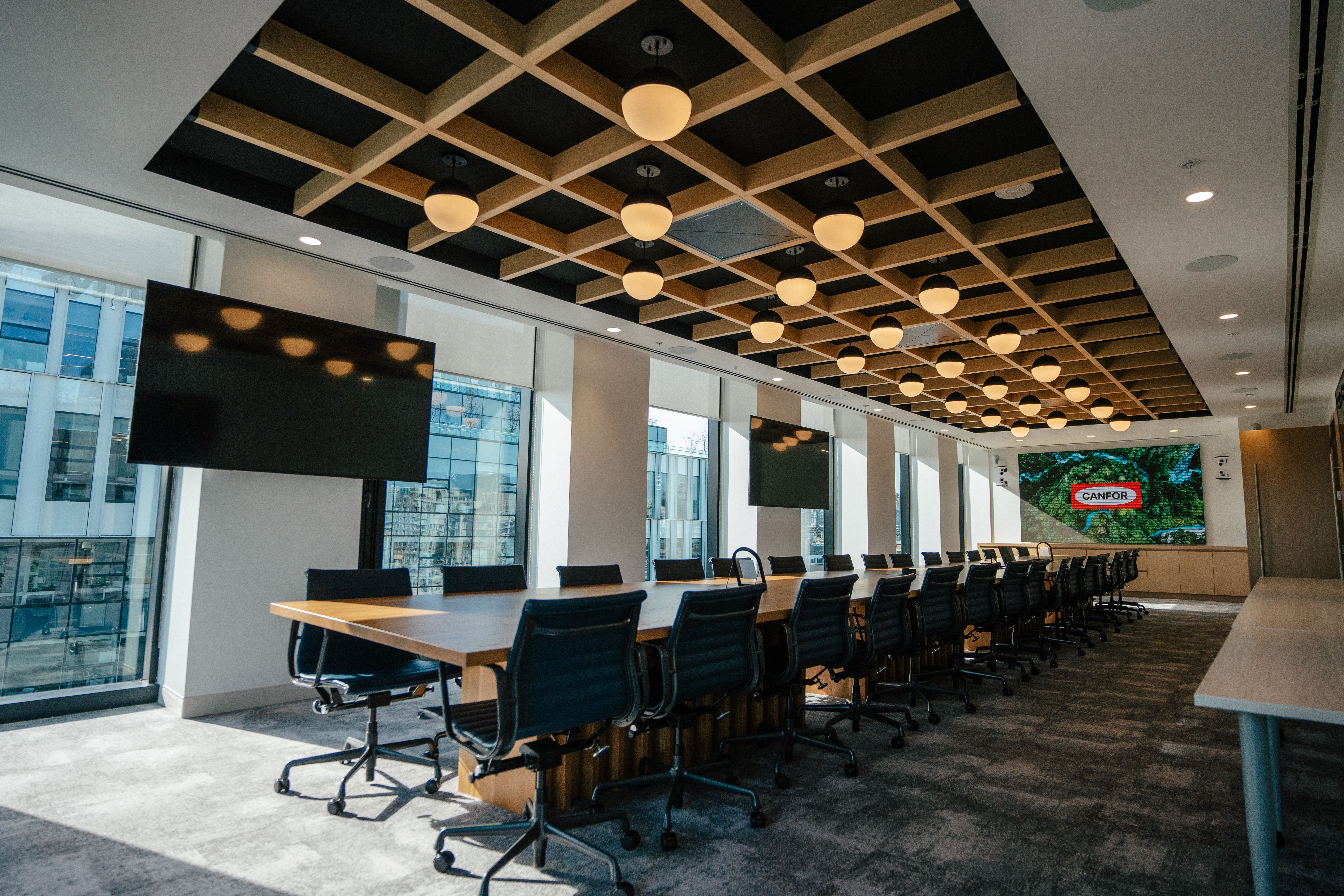 a large conference room with a long table and chairs .