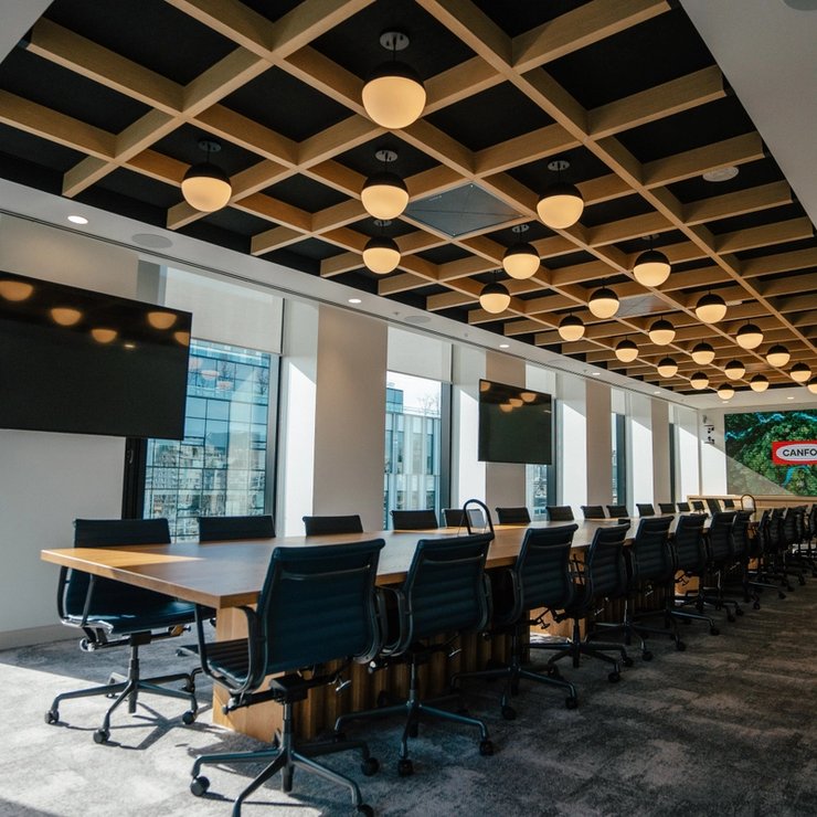 a large conference room with a long table and chairs .