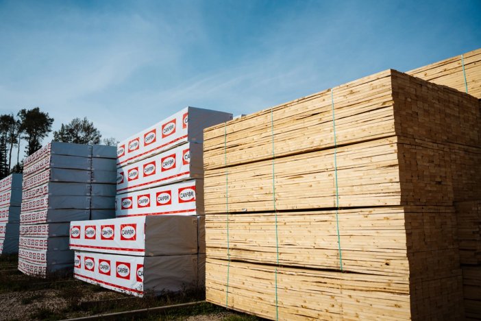 a stack of wooden boards sitting on top of each other in a field .