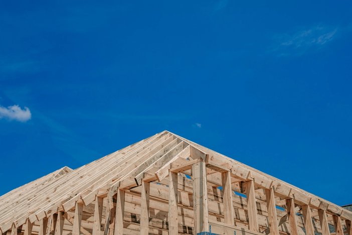 a house is being built with a blue sky in the background .