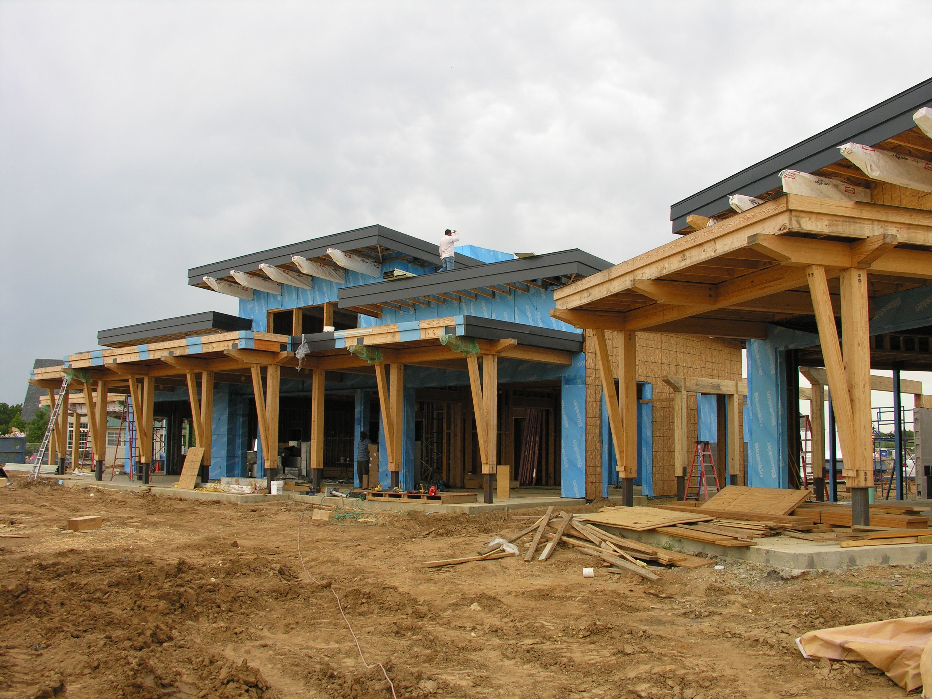 a large house is being built in a dirt field.