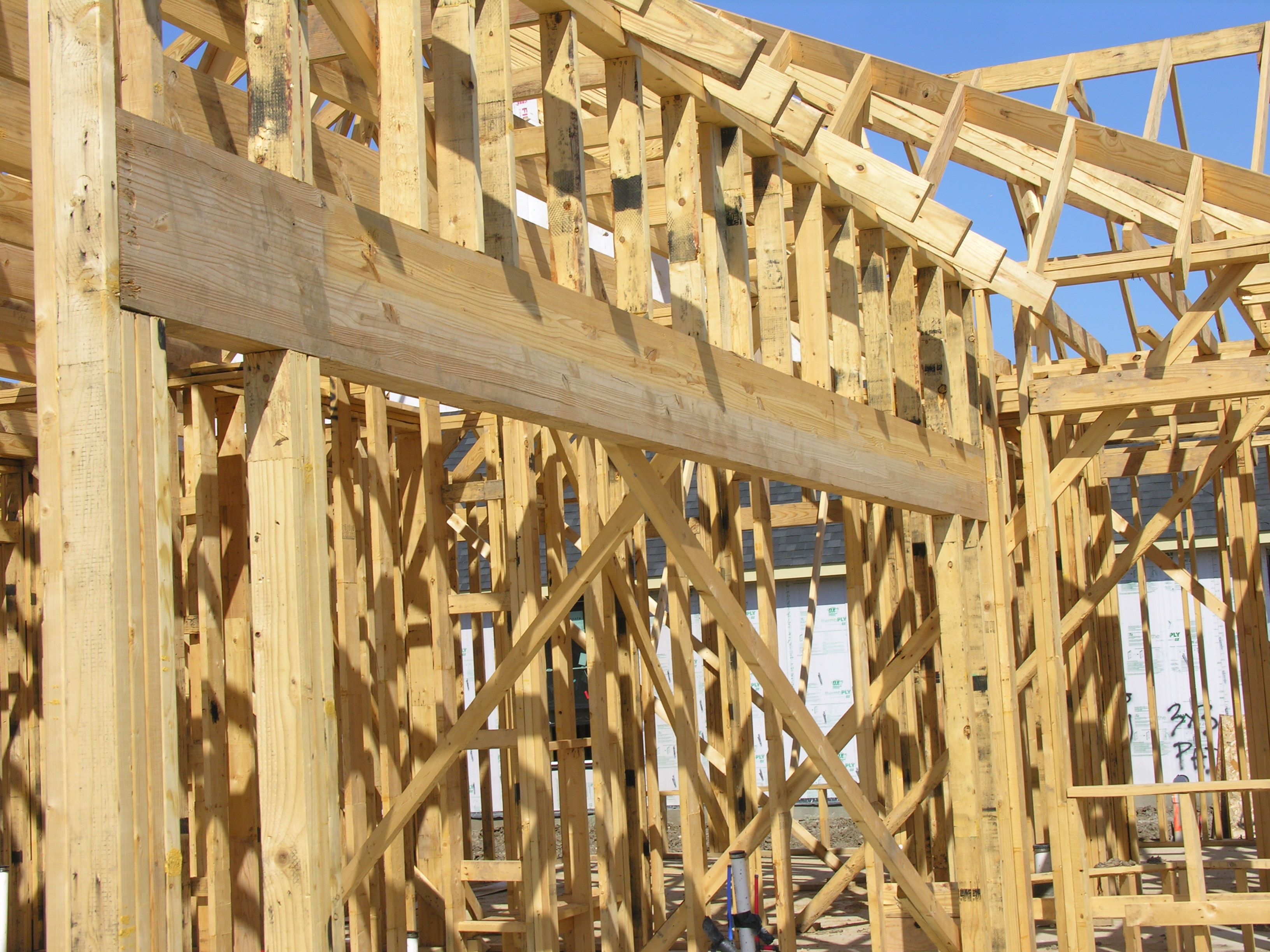 a large wooden structure is being built on a construction site .