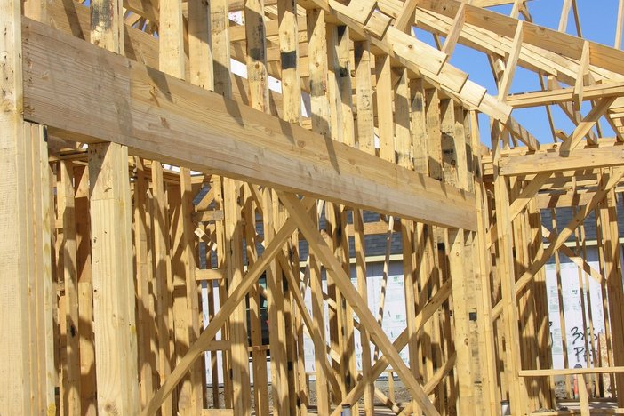 a large wooden structure is being built on a construction site .