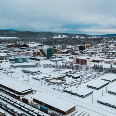 an aerial view of the city of Prince George covered in snow .