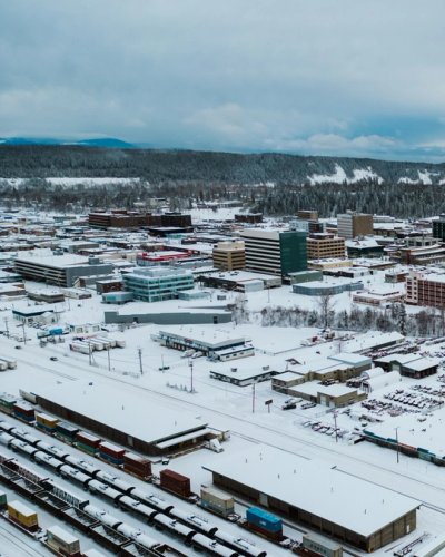 an aerial view of the city of Prince George covered in snow .