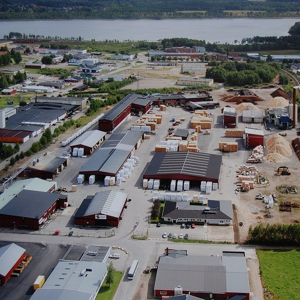 an aerial view of a large industrial area with a lake in the background .