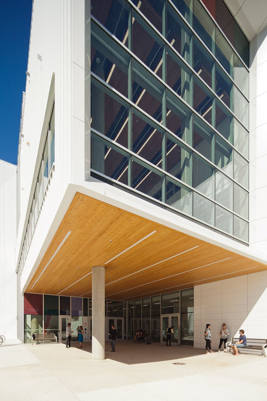 a group of people are standing outside of a large building