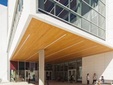 a group of people are standing outside of a large building