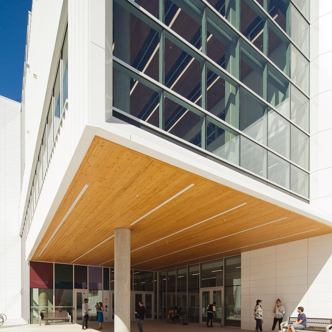 a group of people are standing outside of a large building