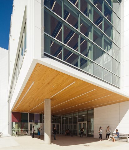 a group of people are standing outside of a large building
