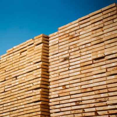 a stack of wooden planks against a blue sky .