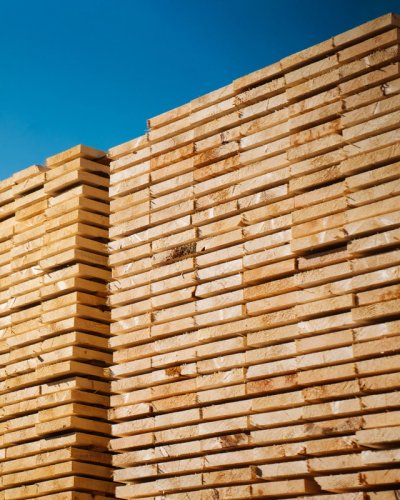 a stack of wooden planks against a blue sky .