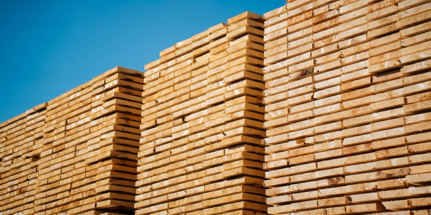 a stack of wooden planks against a blue sky .