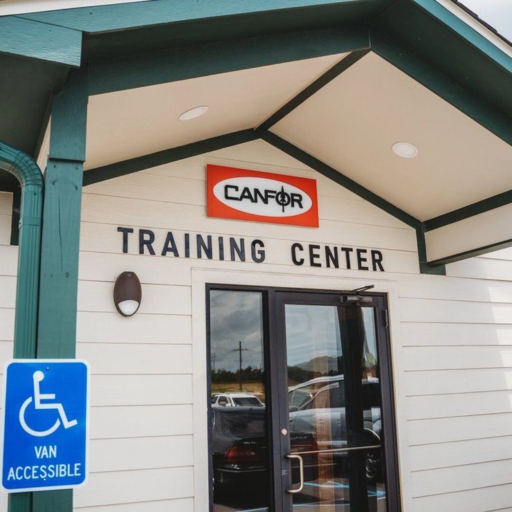 a white building with a handicapped van accessible sign in front of it .